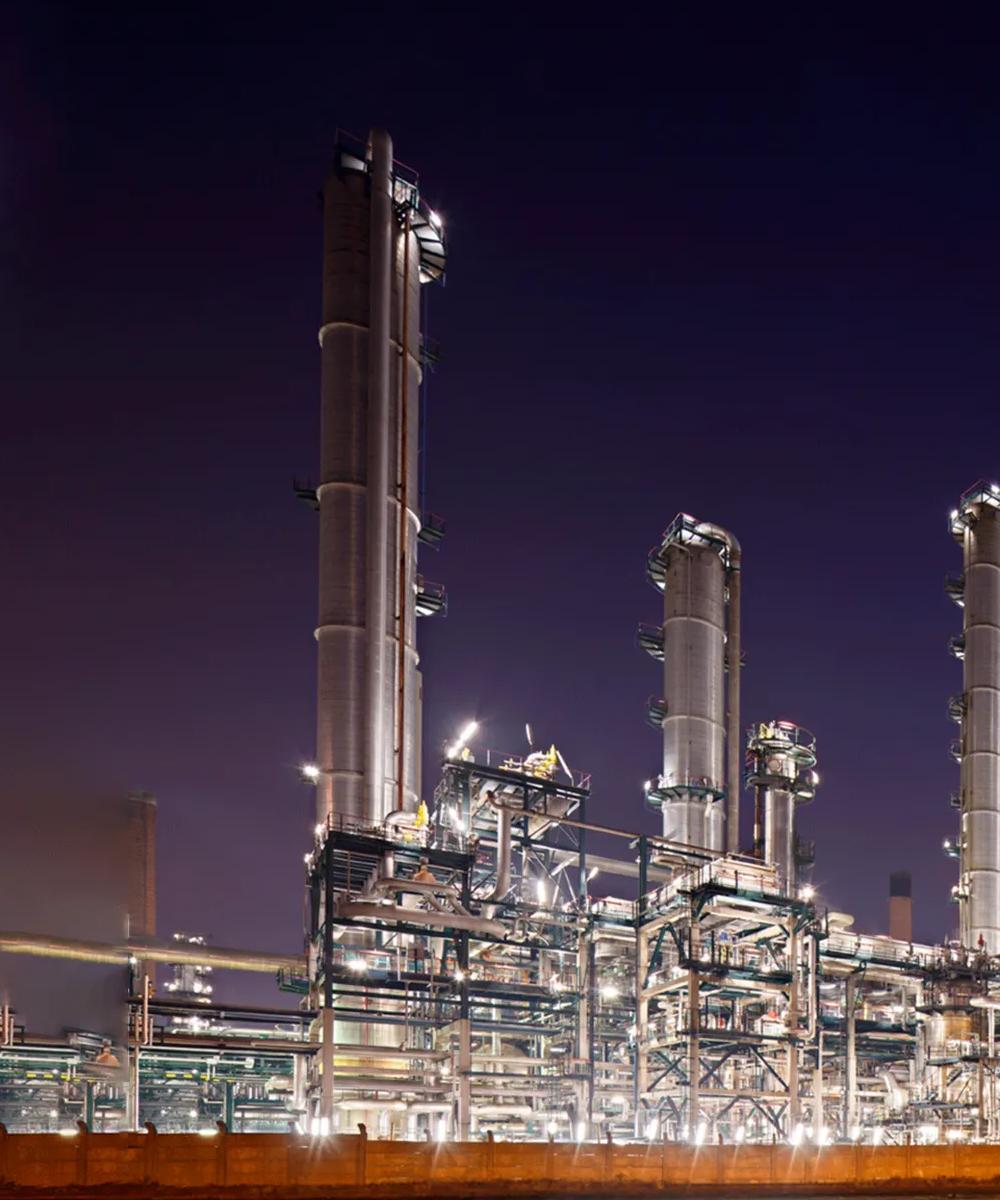 Night-view of a lit-up refinery at a distance.