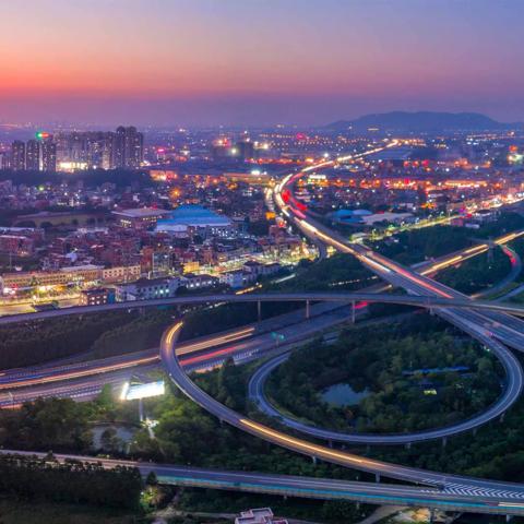 Busy overview of roads and city with sunset