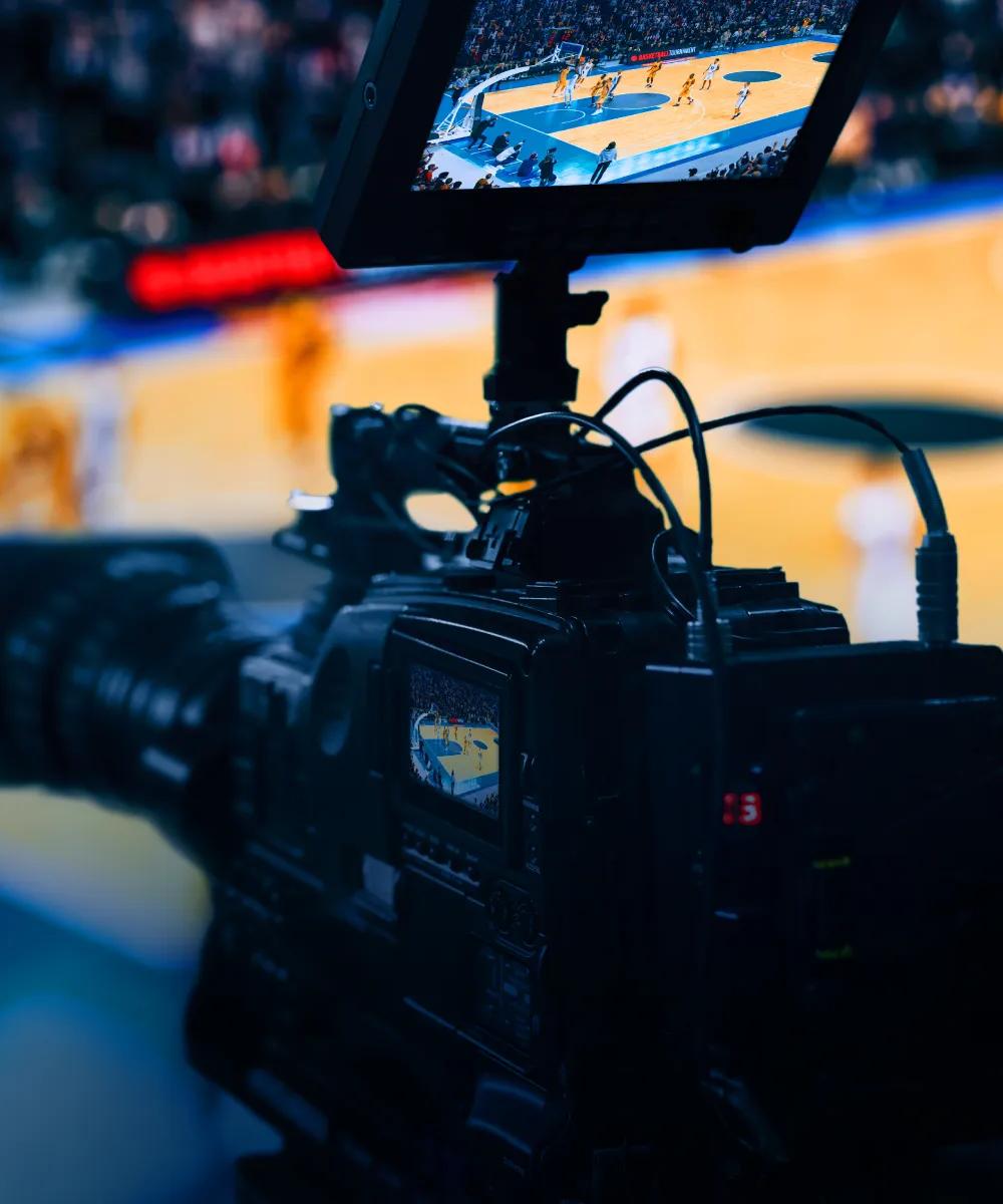 A professional video camera broadcasting a basketball game.