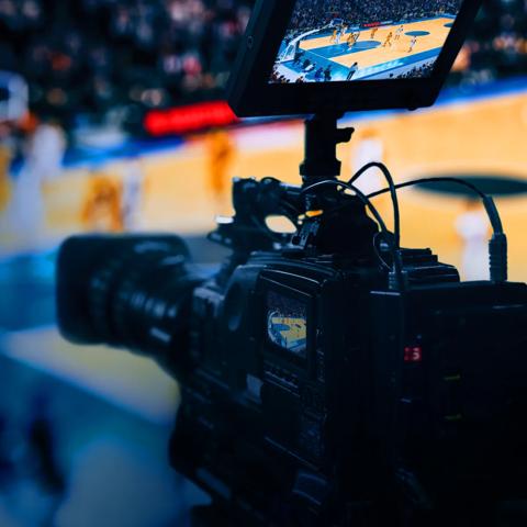 A professional video camera broadcasting a basketball game.