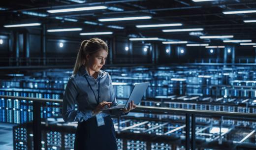 Data Center Female It Specialist Using Laptop. Server Farm Cloud Computing and Cyber Security Maintenance Administrator Working on Computer. Information Technology Professional.