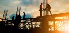 Silhouette of engineer and construction team working at site over blurred background sunset pastel for industry background with Light fair.Create from multiple reference images together.