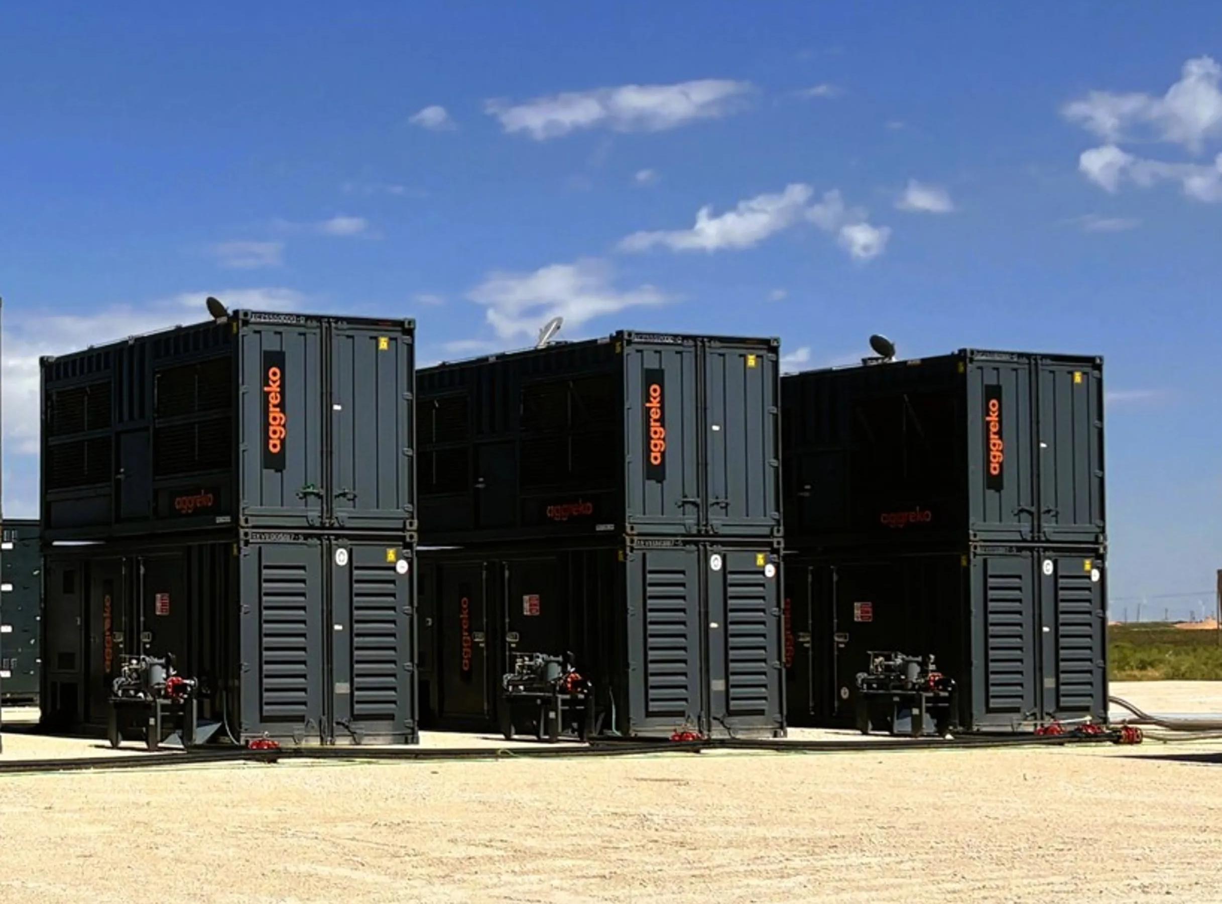 Multiple stacked, black industrial units in a dessert setting.