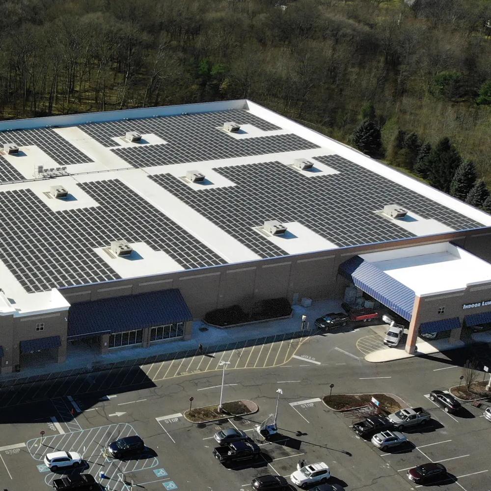 An aerial panoramic view of a large, single-story commercial or retail building.  