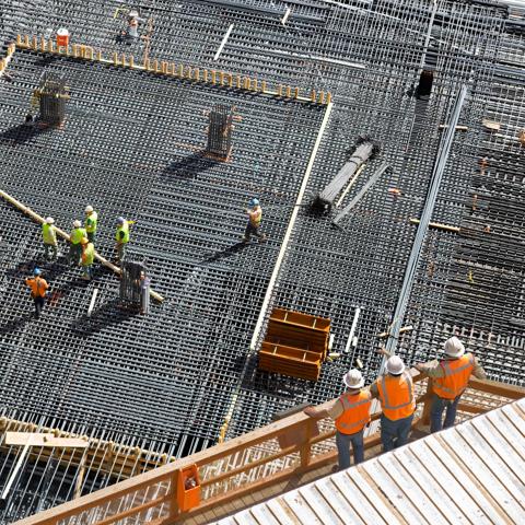 Installing Steel Reinforcement Bars for Concrete Foundation at High-rise Building Site