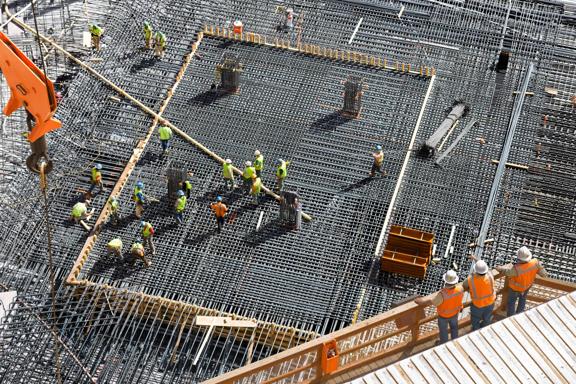 Installing Steel Reinforcement Bars for Concrete Foundation at High-rise Building Site