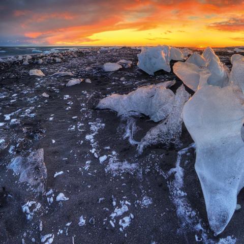 Beautiful sunset over famous Diamond beach Iceland. This sand lava beach is full of many giant ice gems placed near glacier lagoon Jokulsarlon.