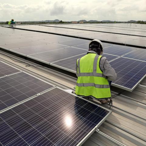 Technician Connecting Cable Solar Rooftop