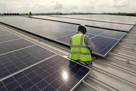 Technician Connecting Solar to hybrid system in Nigeria