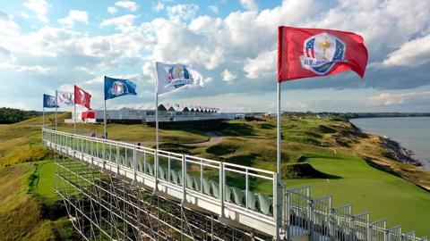 Aerial view of a golf course with bleachers on the side.