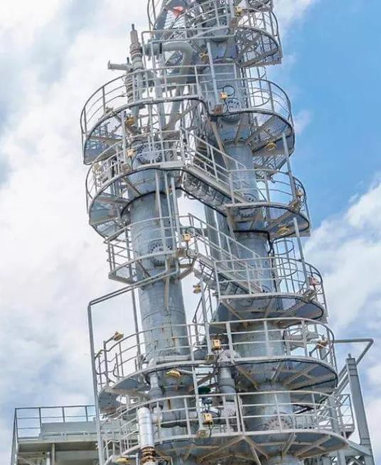 Ground view of a refinery's towers.