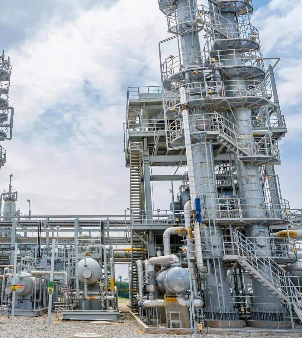 Ground view of a refinery's towers.