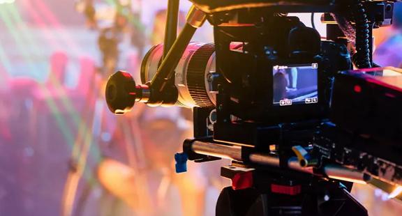 A professional video camera recording in a lively set. 