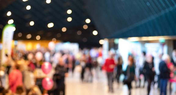 Blurred view of people in an indoors event.