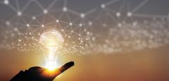 Hand of businessman holding illuminated light bulb, New ideas, innovation and inspiration concepts.
