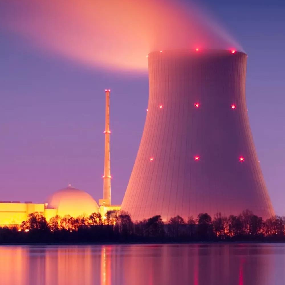 View of a cooling tower from a nuclear plant with pink and purple tones 