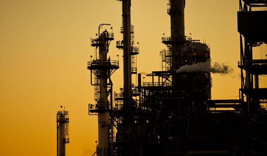 The sun sets behind a major oil refining and chemical processing plant in Martinez, California