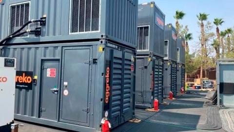 Several black Aggreko units piled on one another.