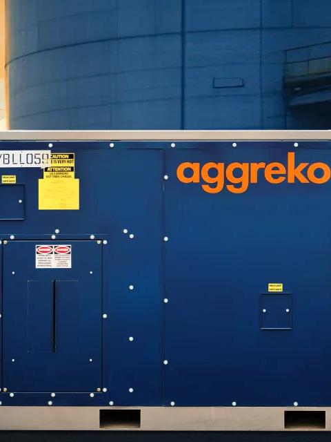 Chauffage bleu Aggreko à l’extérieur d’une installation industrielle.
