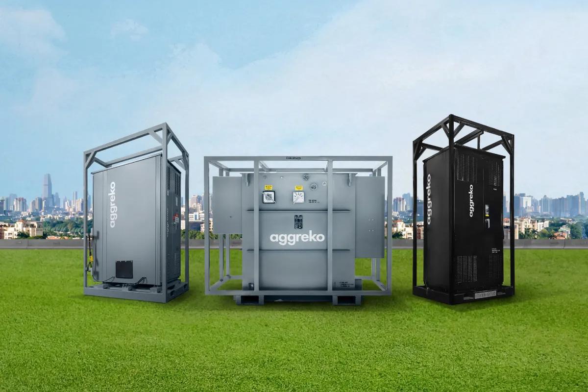 Three Aggreko industrial units standing under a clear sky.