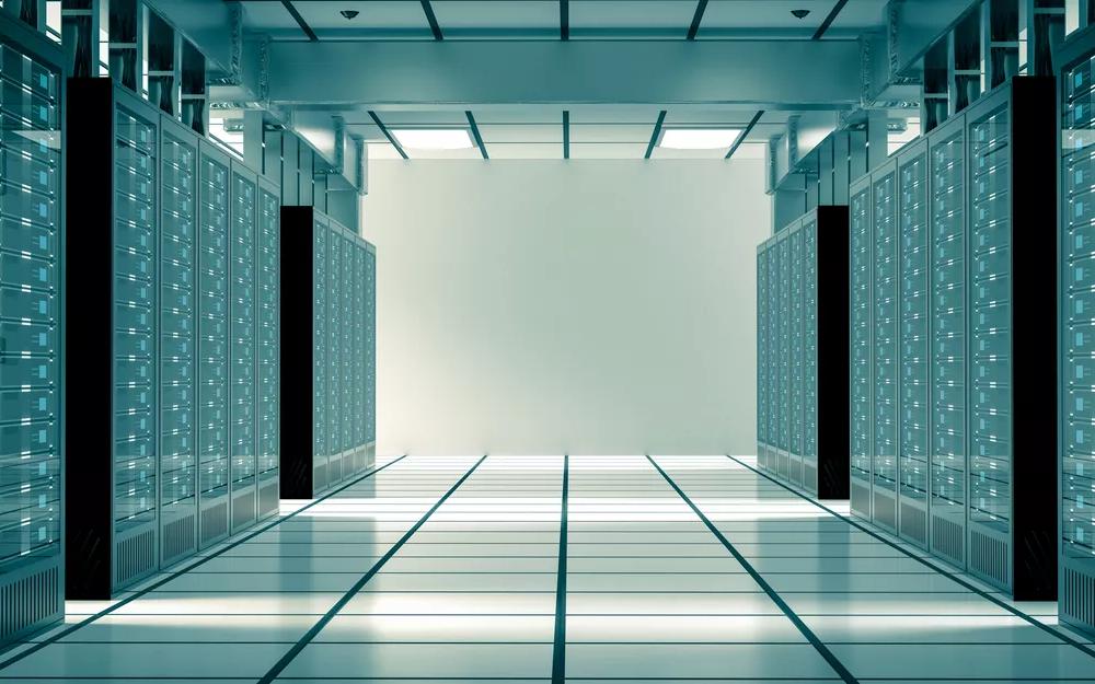 A side view of several rows of dark gray or black server hardware racks, showing the cable management and hardware depth within the server frames.