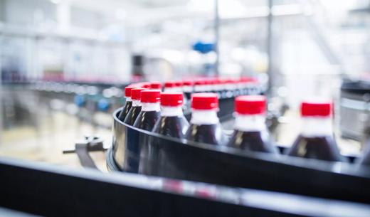 Water bottling line for processing and bottling black carbonated juice into bottles.