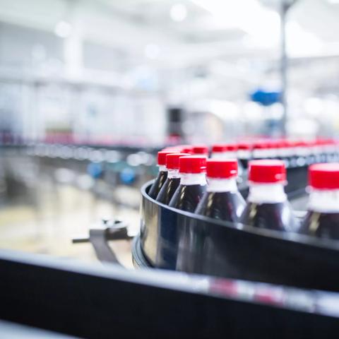 Water bottling line for processing and bottling black carbonated juice into bottles.