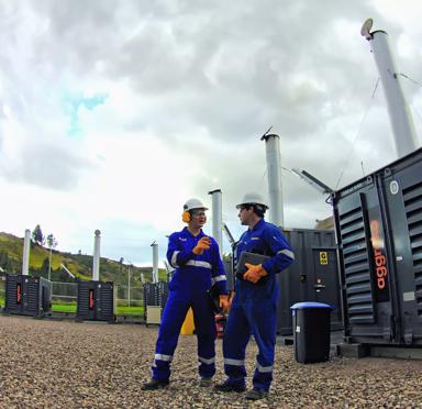Technicians alongside generator