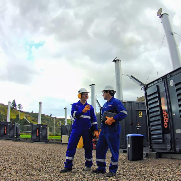 Technicians alongside generator
