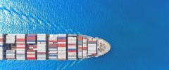 Aerial top view container ship full load container wih beautiful wave pattern for logistics import export, shipping or transportation concept.