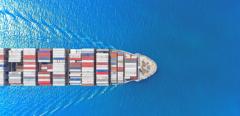 Aerial top view container ship full load container wih beautiful wave pattern for logistics import export, shipping or transportation concept.