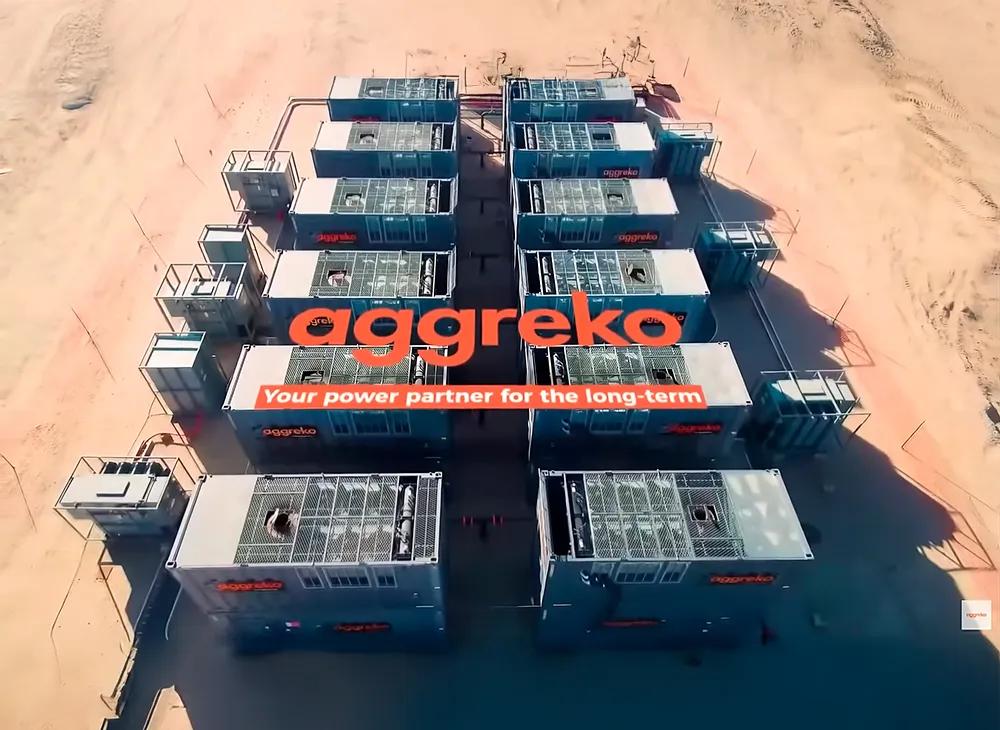 Multiple gray Aggreko generators are outdoors.