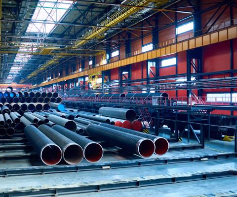 Abundance of tubes used for oil and gas industry placed in factory warehouse