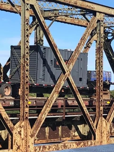 View of an old, rusty railway bridge.