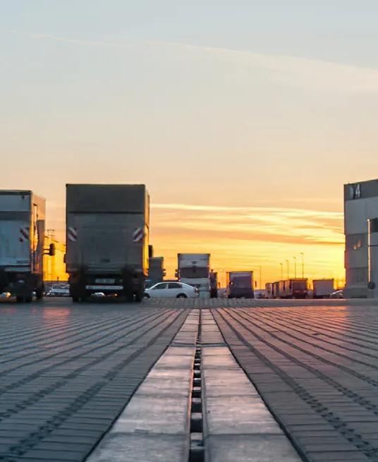 Trucks parked in a facility's parking lot.