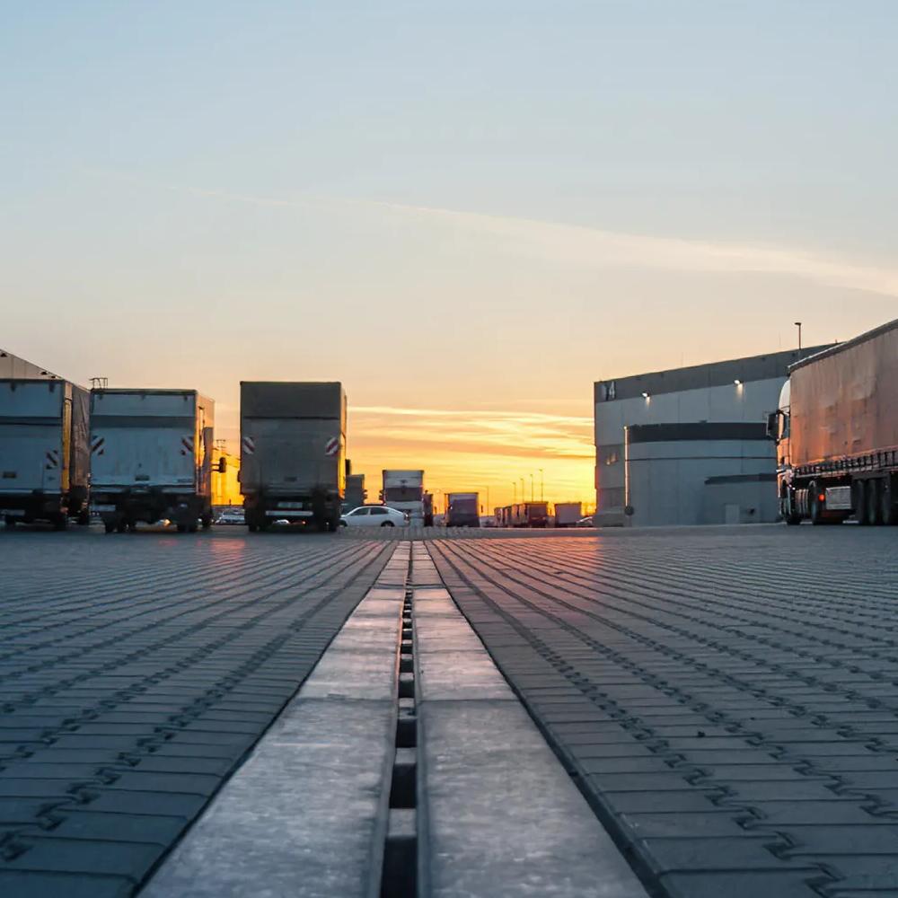 Trucks parked in a facility's parking lot.
