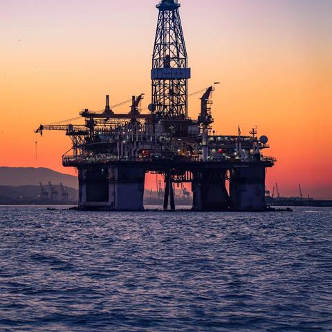 Onshore oil & gas treatment plant against a sunset sky