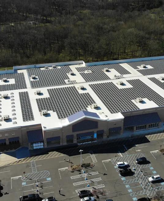 An aerial panoramic view of a large, single-story commercial or retail building.  