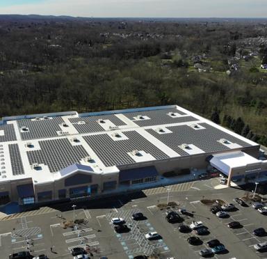 An aerial panoramic view of a large, single-story commercial or retail building.  
