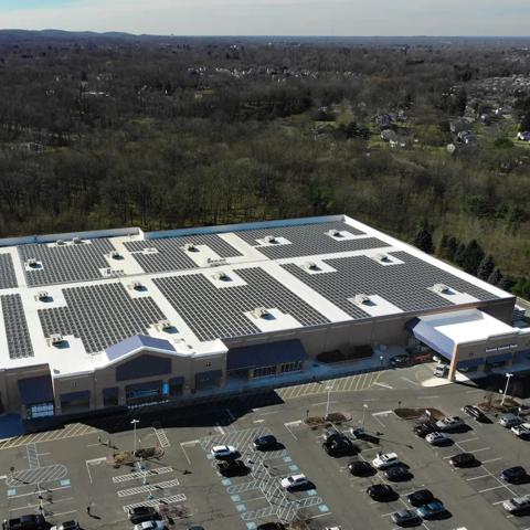 An aerial panoramic view of a large, single-story commercial or retail building.  