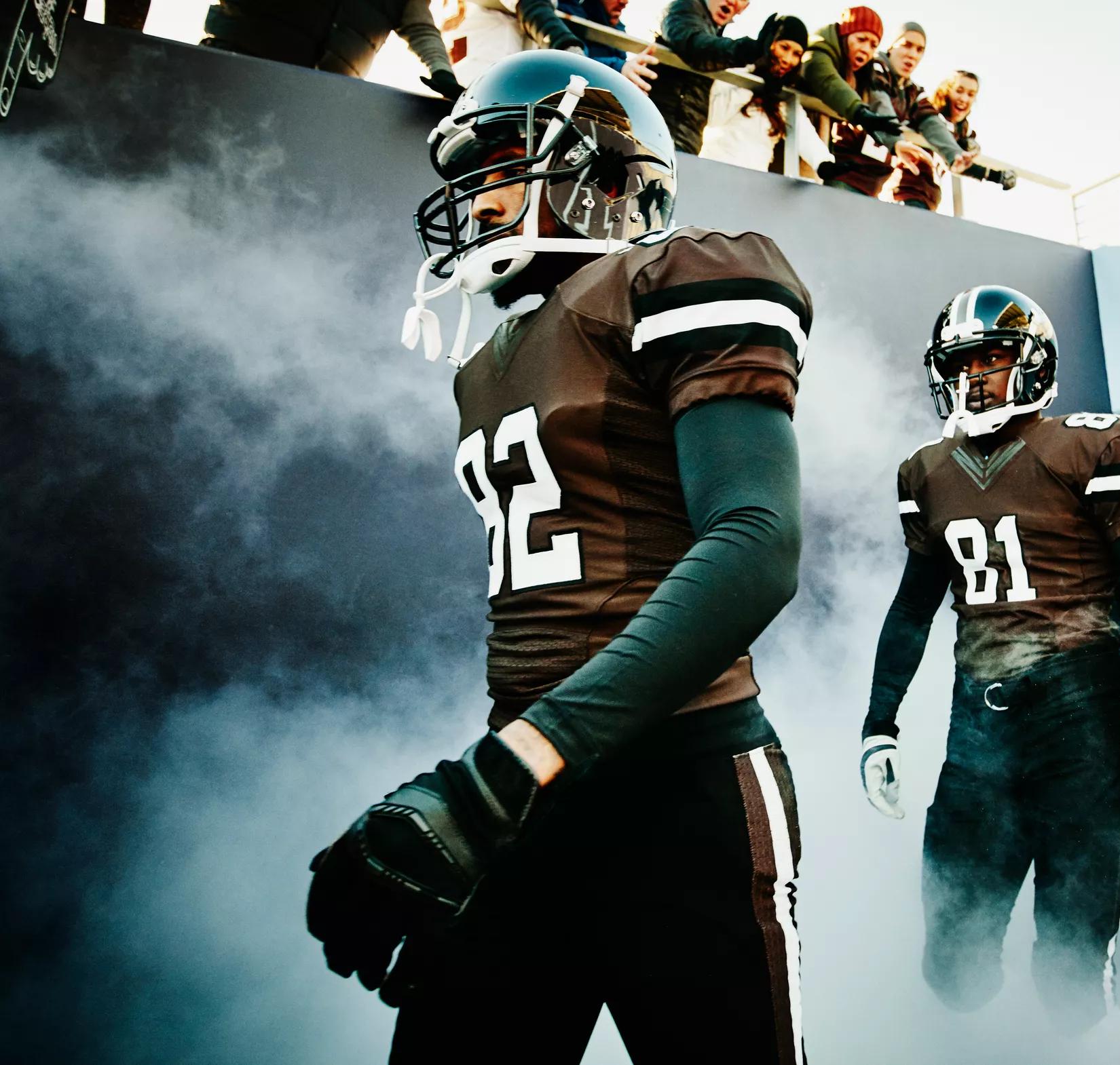Football team stepping into the field. 