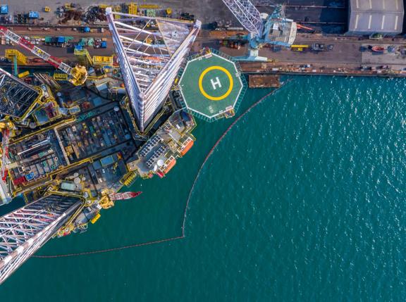 Aerial view maintenance repair of the jack up oil and gas rig up in the shipyard, Offshore oil and Gas processing platform, oil and gas industry.