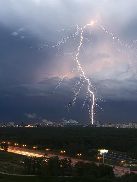 Photo of a lightning strike over a city
